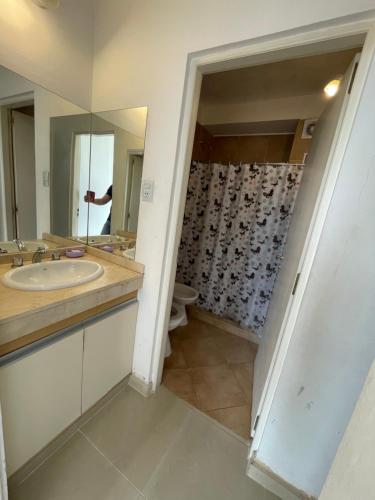 a bathroom with a sink and a mirror at SORRENTO Céntrico con cochera in Villa Carlos Paz