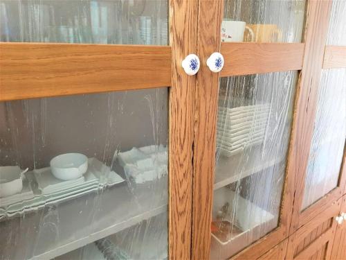 a wooden cabinet with glass doors and knobs on it at Apartamento Calypso in Cabo de Palos