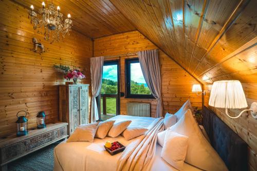 a bedroom with a bed in a wooden room at Piaskowy Koń - Mountain Lodge & SPA- Karkonosze in Mniszków