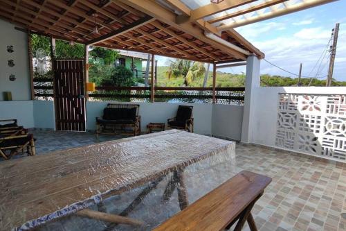 a patio with a wooden table and chairs at Casa Silandia, tu casa en Búzios in Búzios