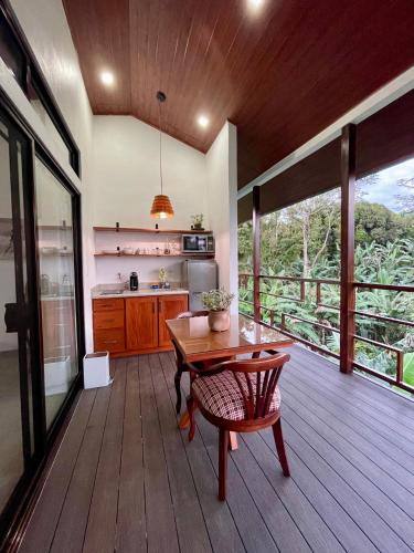 a kitchen with a wooden floor and a wooden table at Casa Donna Rosa B&B in Nuevo Arenal