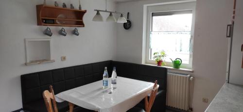 a dining room table with two bottles of wine on it at Wörnitz Haus mit 3 Schlafzimmern in Oettingen in Bayern