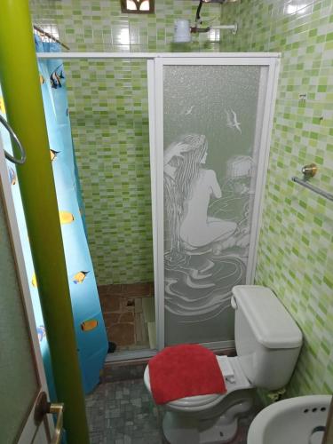 a bathroom with a shower with a mermaid on the door at Vacation home Bellavista in Santo Domingo de los Colorados