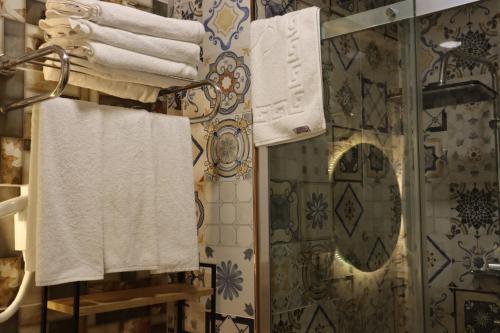 a bathroom with towels on a rack and a shower at Galata istanbul Hotel in Istanbul