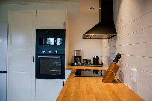 a kitchen with a blue stove top oven next to a counter at Modern Country Apartment in Borlänge
