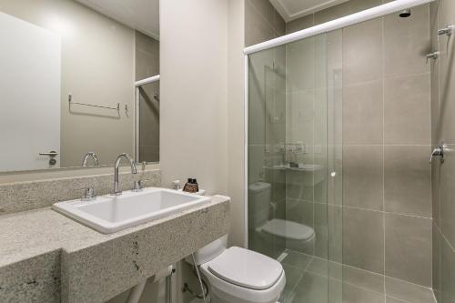 a bathroom with a sink and a toilet and a shower at Wi-FIi | 250MB | Sea View | Pool #CA60 in Florianópolis