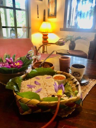 a table with a bowl of food on a table at Captain's Bungalow, Kandy in Arawwawala