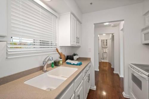 a white kitchen with a sink and a window at Downtown Nashville Riverfront unit 790 in Nashville