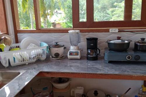 a kitchen counter with a blender and a sink at Palm House Getaway-150 m to sea in Necoclí