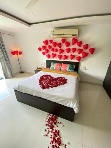 a bedroom with a bed with hearts on the wall at Dukes Den Resort in Lonavala