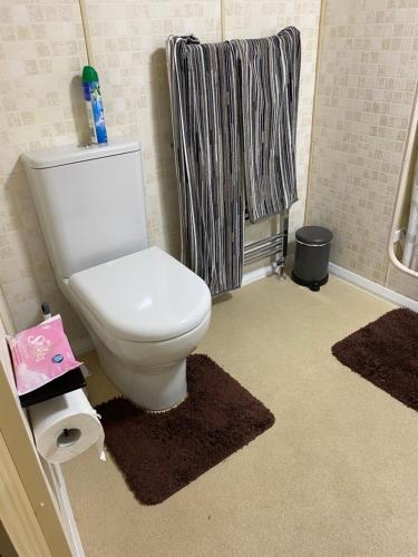 a bathroom with a toilet and a towel at Bobbys Bolthole2 in Heysham