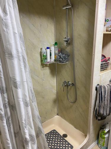 a bathroom with a shower with a shower curtain at Bobbys Bolthole2 in Heysham