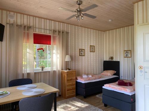 a bedroom with a table and a bed and a table and chairs at Sinisalu Apartments in Käsmu