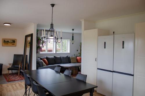 a living room with a table and a couch at Two Large Apartments in Borlänge