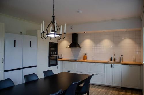 a kitchen with a table and chairs and a dining room at Two Large Apartments in Borlänge