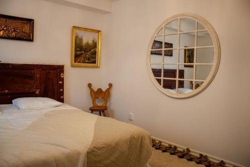 a bedroom with a bed and a mirror on the wall at Two Large Apartments in Borlänge