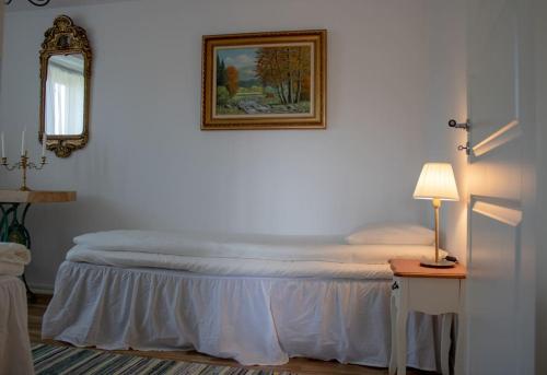 a bed in a room with a picture on the wall at Two Large Apartments in Borlänge