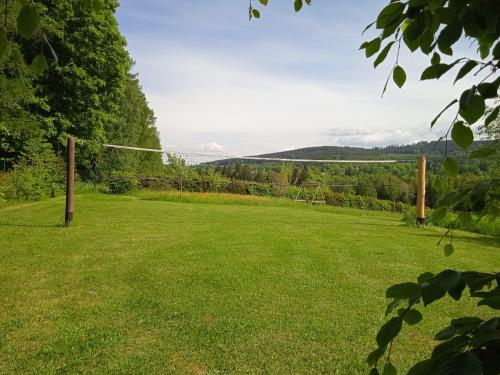 a soccer field with a net in a field at Srub Javorná - apartmány Šumava in Javorná