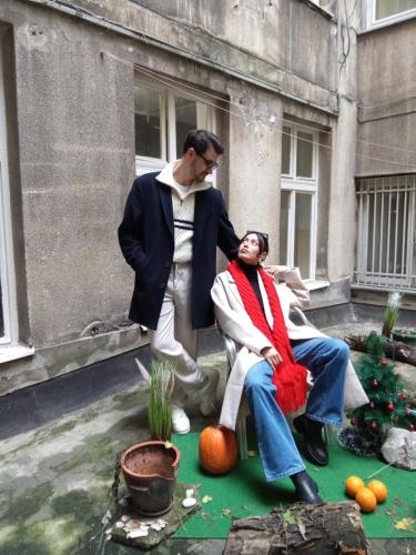 a man standing next to a woman sitting on a pumpkin at Jasmin in Belgrade