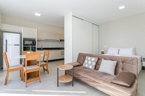 a living room with a couch and a bed at Wi-Fi 250MB | Sea View | Pool #CA61 in Florianópolis