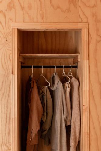 a closet with a rack of clothes at Le Crustacé 2 a 4 personnes in Nouvelle