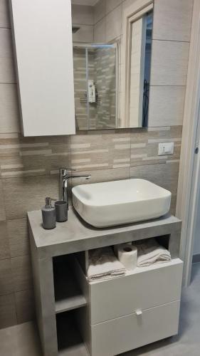 a bathroom with a sink and a mirror at CASA VACANZA PARADISO in Manfredonia