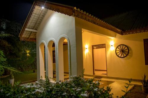 a house at night with a clock on the wall at Woradi Solitude Bungalow in Talpe