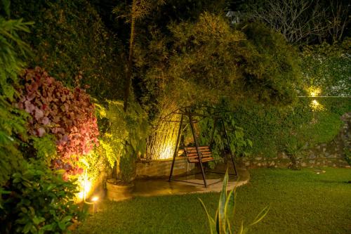 a park bench in a garden at night at Woradi Solitude Bungalow in Talpe