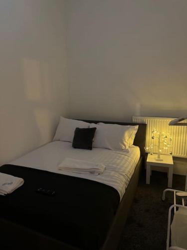 a bed with white sheets and pillows in a room at Room 3 • Double Bed in London King’s Cross in London