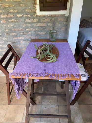 a purple table with a plate of vegetables on it at Costa Villa in Atlántida