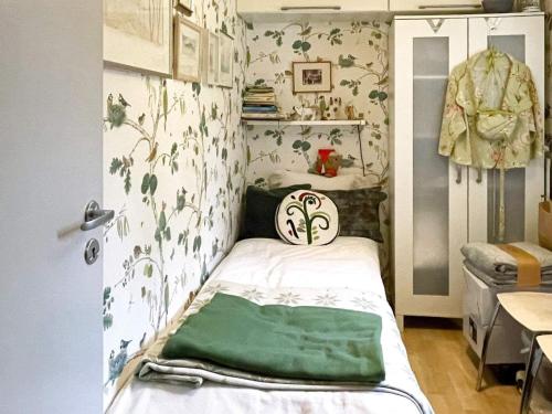 Holiday home NÄSSJÖ III في ناسشو: غرفة صغيرة مع سرير وبطانية خضراء