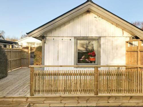 a small house with a window on a wooden deck at 2 person holiday home in Falkenberg in Falkenberg