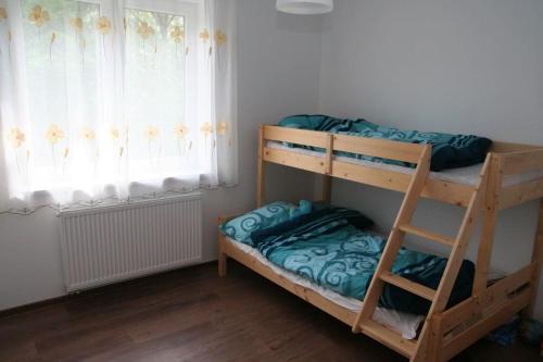 a bunk bed in a room with a window at Porąbka - nocleg w urokliwym miejscu in Porąbka