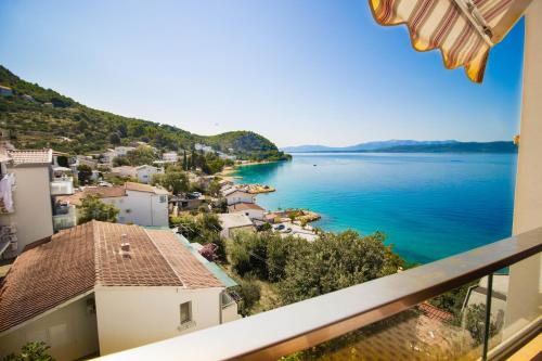 a view of a body of water from a balcony at Apartments Mersab in Živogošće