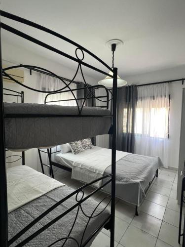 a bedroom with two bunk beds in a room at Chalkidiki Apartment Kallikratia Maria in Nea Kalikratia