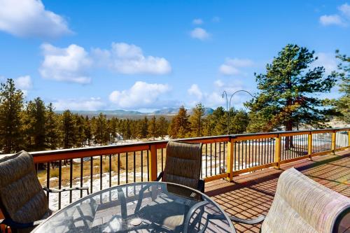 a patio with a table and chairs on a balcony at Avalanche Ranch in Florissant