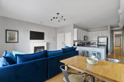 a living room with a blue couch and a table at The Upscale Getaway Near Downtown in Chicago