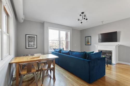 a living room with a blue couch and a table at The Upscale Getaway Near Downtown in Chicago