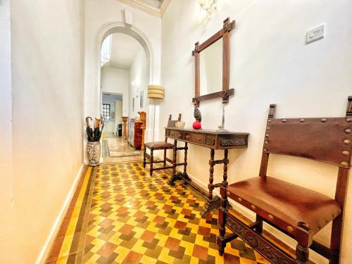 a hallway with a table and chairs in a building at House of Pomegranates in Sliema