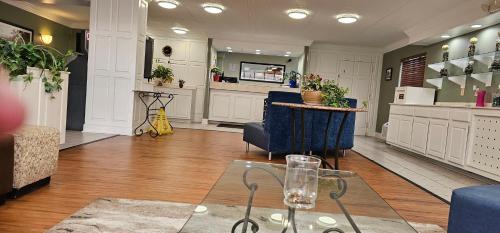 a large living room with a table and chairs at Astoria Hotel West in Danville