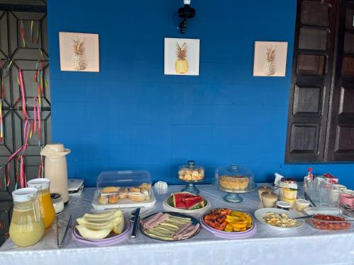 a table with many plates of food on it at Pousada Biribiri in Salvador