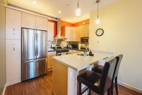 a kitchen with a stainless steel refrigerator and a counter at The Niven Lake Retreat in Yellowknife