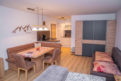 a kitchen and living room with a table and a couch at MountainLOVE in Strobl