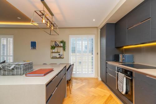 a kitchen with black cabinets and a counter top at Entire Apartment - City Centre - Free Parking in York