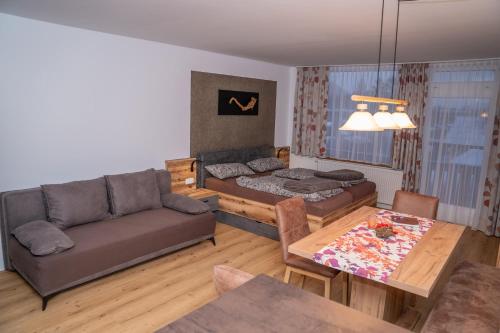 a living room with a couch and a table at MountainLOVE in Strobl