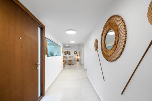 um corredor com paredes brancas e um espelho na parede em Jumeirah Three Bedroom House no Dubai