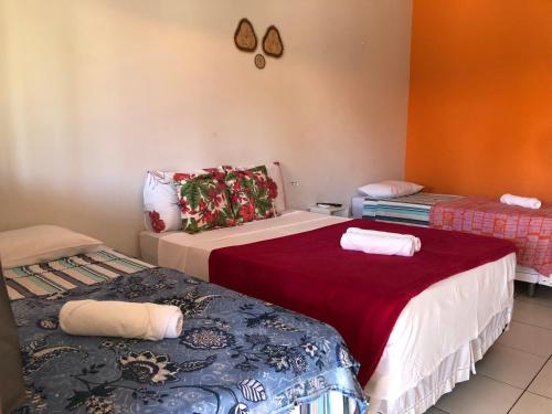 a room with two beds in a room at Pousada Chácara do Coqueiro in Barreirinhas