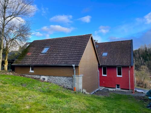 a large house with a red garage at Harzhaus Drei Hexen in Tanne