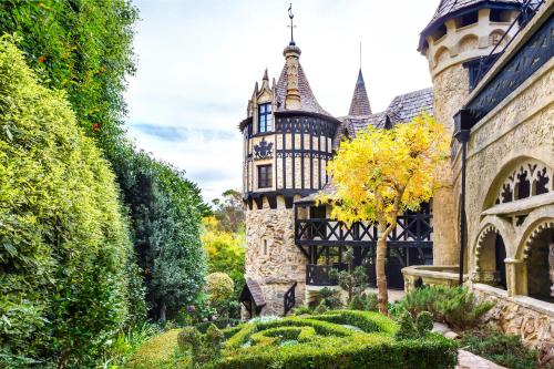 an old castle with a garden in front of it at Castle Keep B&B in the Tower. in Crafers