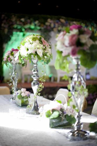 a table topped with two vases filled with flowers at eL Hotel Jakarta in Jakarta